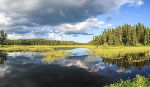 Blue mirror lake reflections of clouds and landscape. Sudbury, Ontario, Canada. Stock-Fotos