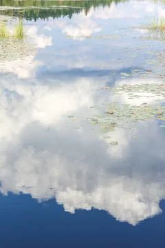 Blue mirror lake reflections of clouds and landscape. Sudbury, Ontario, Canada. Stock-Fotos