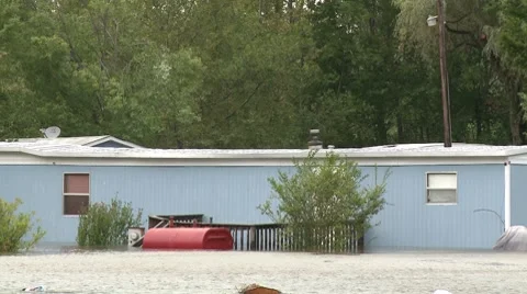 A blue mobile home is surrounded by flood waters after Hurricane Irene Stock Footage 8567337