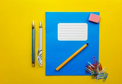 Blue mock up notebook and textbook butt for school subjects, eraser, pencil.. Stock Photos