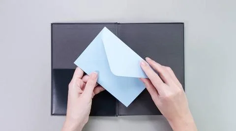 Blue mockup envelop with empty space for text and design in hand of young ... Stock Photos