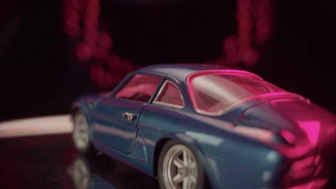 Blue model car displayed with vibrant lighting in creative setting Stock Footage 319901272
