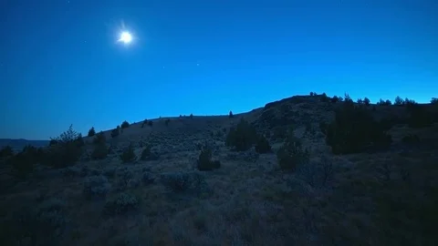 Blue moon at dusk across the open desert time lapse night Stock Footage 81801898