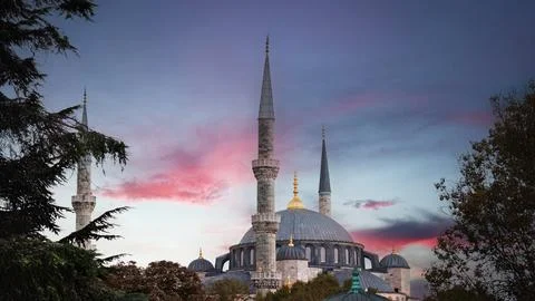 Blue Mosque at sunset with pink clouds, ideal for Ramadan-themed background. Stock Photos