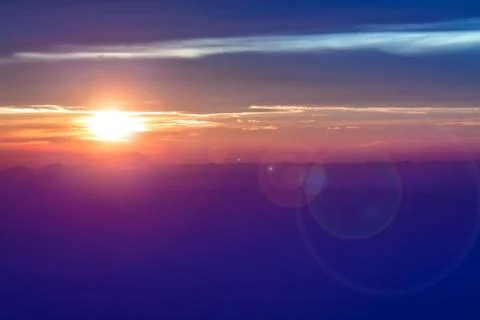 Blue mountain with orange sky while rising sun Stock Photos