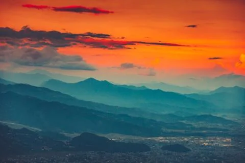 Blue mountain range and orange sunset cloudy sky Stockfoto's