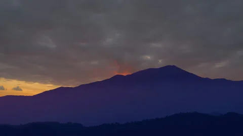 Blue mountain silhouette under a dense cloudy sky Stock Footage 150682931