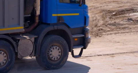 Blue multi-axle truck loaded with earth is drives to unload  Stock Footage 147634767