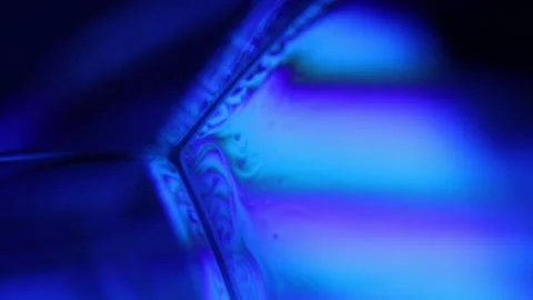 Blue multi-colored liquid in macro, color change and reflection Stock Footage 279484494
