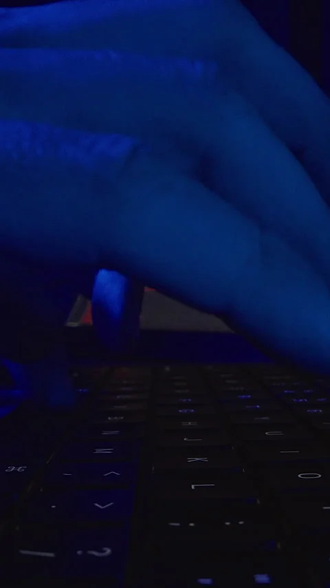 Blue Neon Closeup Dolly Slider Shot of Hand Typing on Laptop Keyboard With Progr Stock Footage 334962655