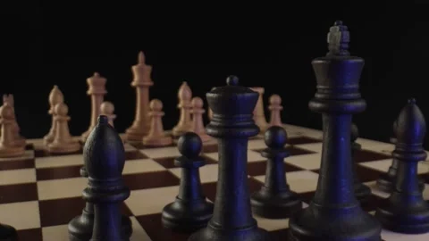 Blue neon light falls on rows of black chess pieces. Arrangement of chess pieces Stock Footage 164632148