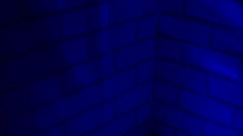 Blue neon light glowing across brick wall texture creating atmospheric urban abs Stock Footage 336247001