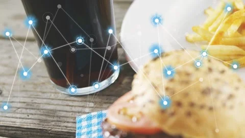 Blue node network appearing over glass, spreading toward burger and fries, Stock Footage 333950369