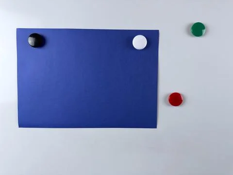 Blue note paper attached to whiteboard with colorful magnets perfect for re.. Stock Photos