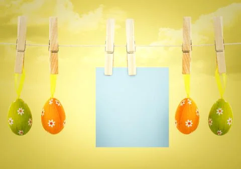 Blue note on washing line with eggs against yellow sky Stock Illustration