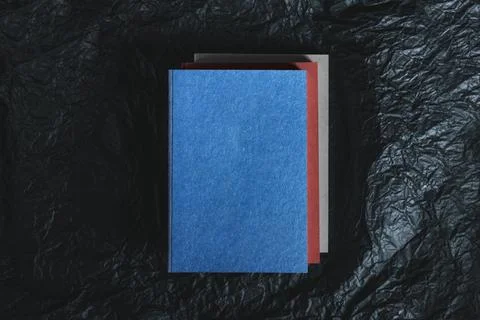 Blue notebook on dark textured background. Space for text.Top view Stock Photos