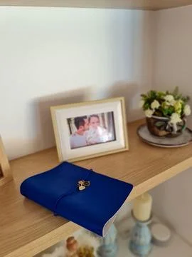 Blue notebook on decorative shelf Stock Photos
