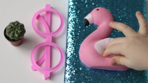 Blue notebook with glitter and soft toy pink flamindo on desk Stock Footage 231978440