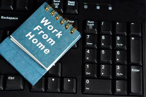 Blue notebook with text written on top of black keyboard on the table Stock Photos