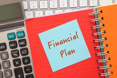Blue notepad with words " Financial Plan " on paper book Stock Photos