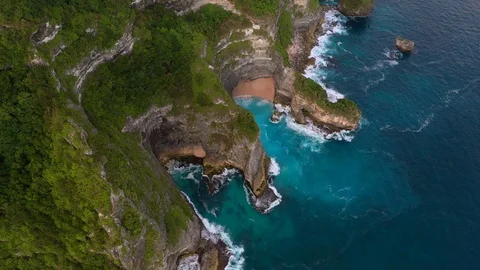 Blue ocean and cliffs covered with trees and grass. Bali shores from above. Aeri Stock Footage 109796752