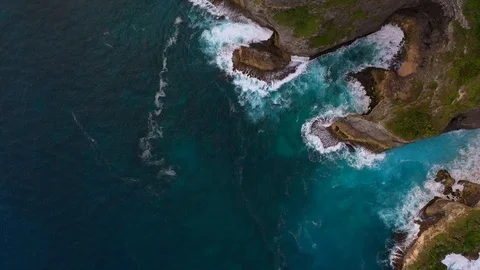 Blue ocean and cliffs covered with trees and grass. Bali shores from above. Aeri Stock Footage 109796769