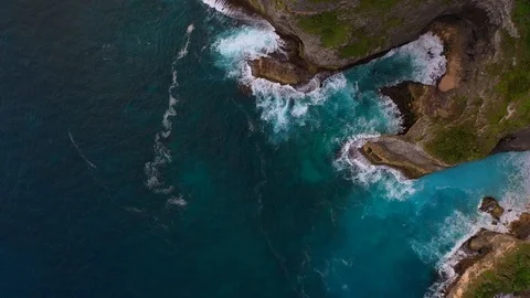 Blue ocean and cliffs covered with trees and grass. Bali shores from above. Aeri Stock Footage 109796780