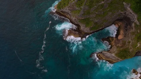 Blue ocean and cliffs covered with trees and grass. Bali shores from above. Aeri Stock Footage 109796788