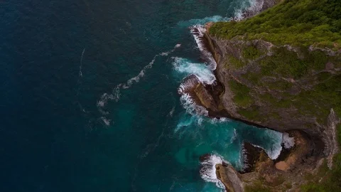 Blue ocean and cliffs covered with trees and grass. Bali shores from above. Aeri Stock Footage 109796802