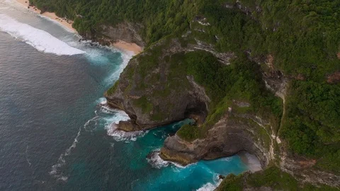 Blue ocean and cliffs covered with trees and grass. Bali shores from above. Aeri Stock Footage 109796822