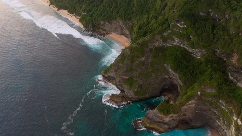 Blue ocean and cliffs covered with trees and grass. Bali shores from above. Aeri Stock Footage 109796827