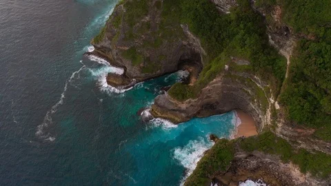 Blue ocean and cliffs covered with trees and grass. Bali shores from above. Aeri Stock Footage 109796843