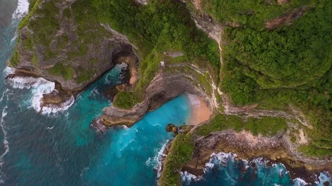 Blue ocean and cliffs covered with trees and grass. Bali shores from above. Aeri Stock Footage 109796893