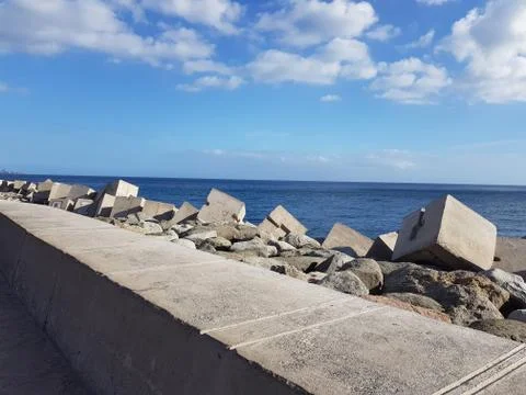 Blue ocean with massive stone casting on the canary islands Stock Photos