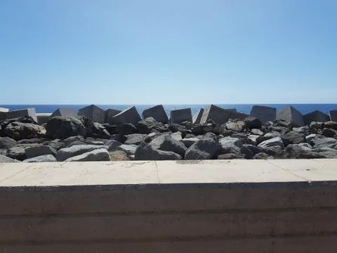 Blue ocean with massive stone casting on the canary islands Stock Photos