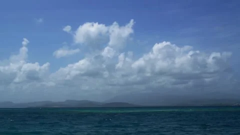 Blue ocean meets sky with clouds above Stock Footage 329545638