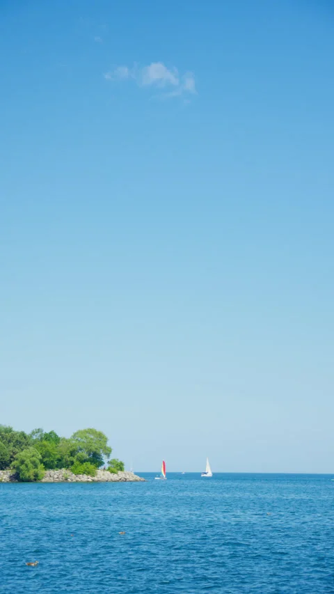 Blue ocean sailboat in the distance Stock Footage 340989480