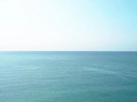 Blue ocean. Small waves. A direct horizon and an immense distance. Clear, blue Stock Photos
