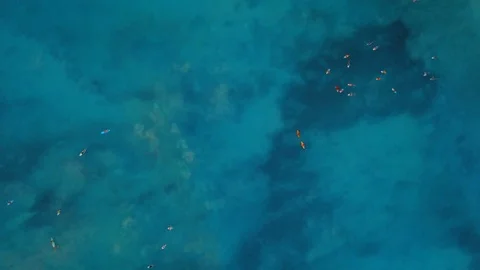 Blue ocean water surface with many surfers on spot, aerial view Stock Footage 94152391