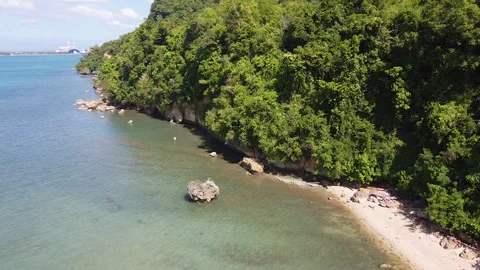 Blue Ocean Waters with Mountain Side and a Big Rock Video stock 261022737