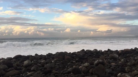 Blue Ocean Wave, Black volcanic rocks and blue and white sky Stock Footage 121139895