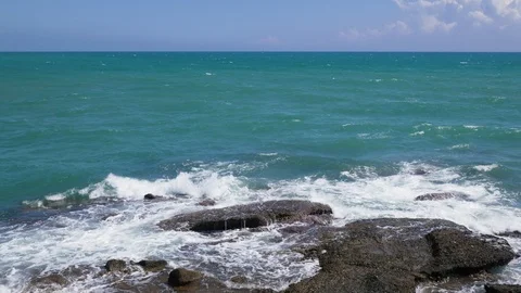 Blue ocean waves break on rocks Video stock 95269765