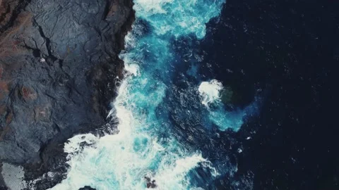 Blue ocean waves crashing onto the cliffs Video stock 237882615