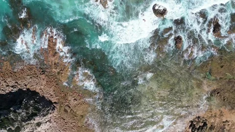 Blue ocean waves crashing onto rocks - relaxing - calming Stock Footage 297119334