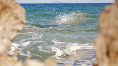 Blue ocean waves crashing through a natural rock frame view. Stock Footage 337406780