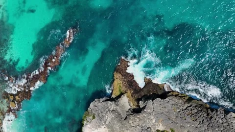 Blue Ocean Waves Texture Background with Rocky Coastline Stock Footage 329628453