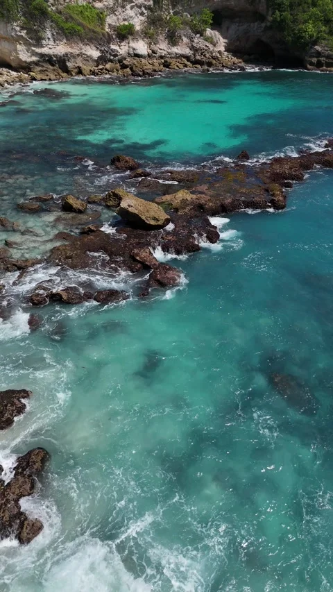 Blue Ocean Waves Texture Background with Rocky Coastline Stock Footage 330285463