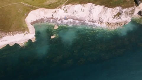 A blue ocean with a white cliff in the background Stock Footage 297950186