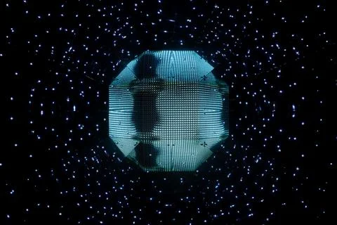 Blue octagonal object in space surrounded by tiny white stars Stock Photos