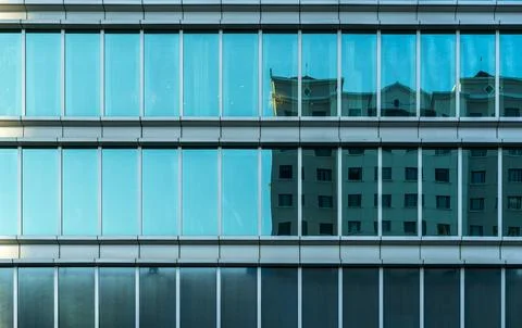 Blue office building seen from a distance with many glass windows Stock Photos
